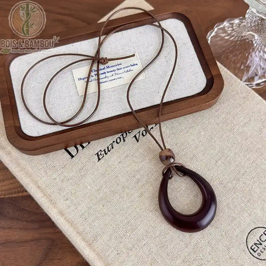 collier long bois sculpté modèle 3 pendentif anneau ovale ajouré brun-bordeaux cordon brun réglable