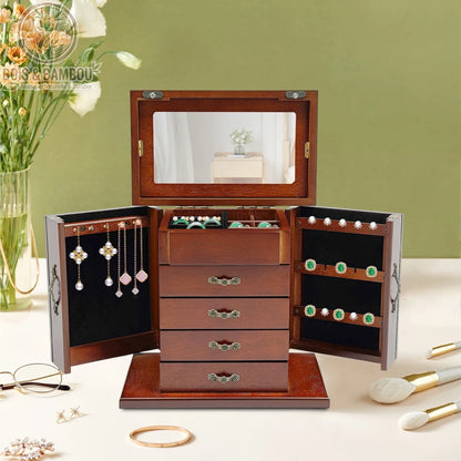 Boîte à bijoux vintage en bois précieux avec portes latérales battantes, tiroirs multiples et miroir. Fabrication artisanale au style rétro élégant pour le rangement de colliers, boucles d'oreilles et bagues.