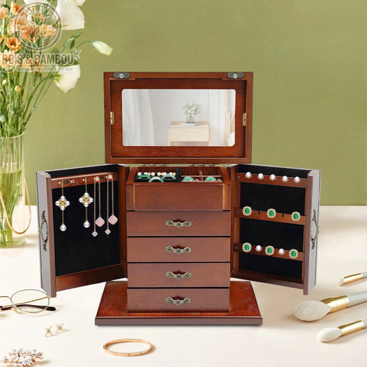 Boîte à bijoux vintage en bois précieux avec portes latérales battantes, tiroirs multiples et miroir. Fabrication artisanale au style rétro élégant pour le rangement de colliers, boucles d'oreilles et bagues.