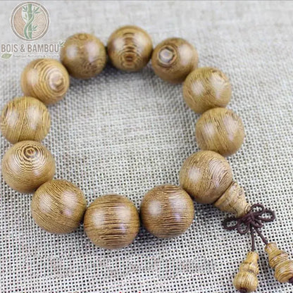 Bracelet mala bois de wengé 12 perles 20 mm fond lin avec clochette gourde en bois pendante