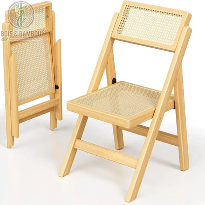 Chaise Pliante en Rotin situation. Deux chaises pliantes en bois clair et cannage de rotin sur fond blanc, l'une ouverte prête à l'emploi et l'autre repliée pour un gain de place.