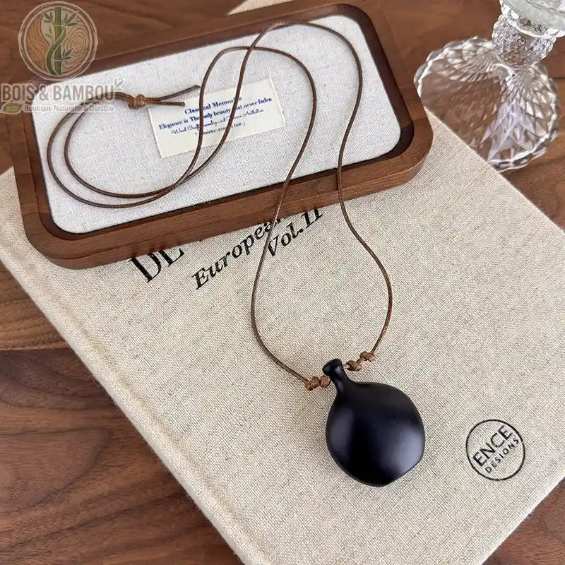 collier long bois sculpté modèle 2 pendentif vase arrondi bois noir mat cordon brun fin réglable