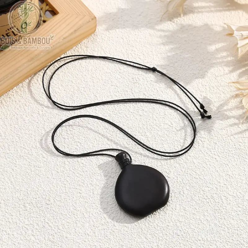 Collier pendentif bois sculpté galet rond plat noir cordon noir ajustable