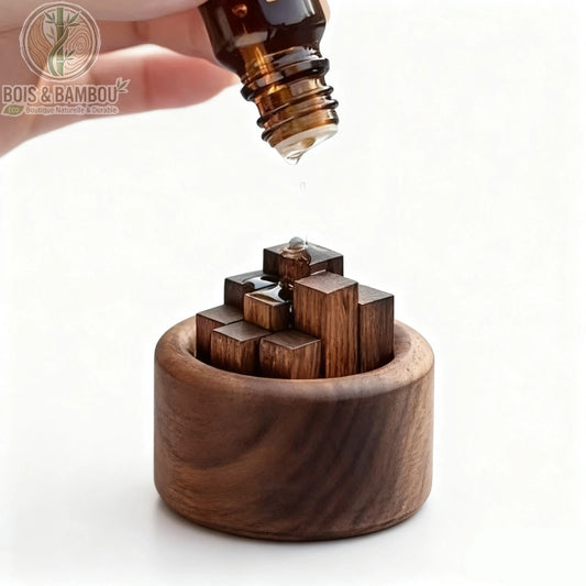 Diffuseur passif en bois noble Chaidui, un socle circulaire en bois naturel contenant plusieurs petits blocs rectangulaires de hauteurs variées, présenté avec une main versant une goutte d'huile essentielle sur le bois pour une diffusion douce et naturelle.