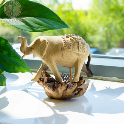 Éléphant en bois sculpté posé sur un rebord de fenêtre