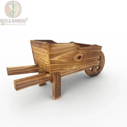 Vue de côté jardinière brouette bois brûlé, roue et brancards apparents, style campagne