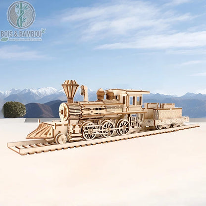Maquette de Train à vapeur Sakura Station. Une réplique détaillée d'une locomotive à vapeur avec son tender sur des rails, réalisée en bois découpé devant un paysage de montagnes.