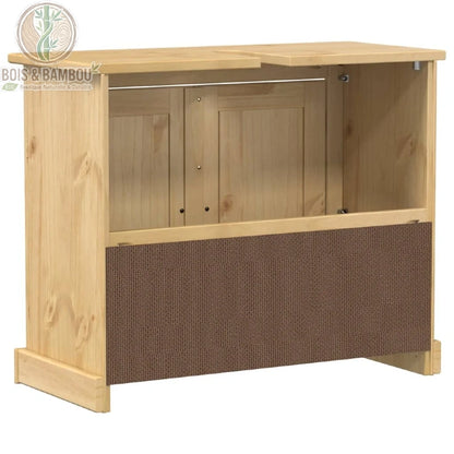Meuble de Salle de Bain Corona arriere. Vue arrière d'un meuble sous-évier en pin clair montrant un panneau inférieur brun texturé et une large ouverture pour le passage de la tuyauterie.