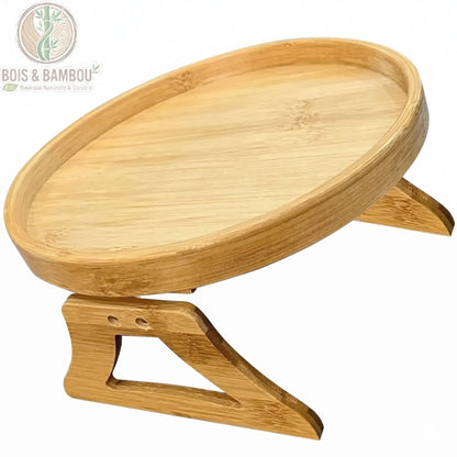 Plateau d accoudoir de canape en bambou rond details. Zoom sur les finitions d'un plateau circulaire en bambou naturel montrant la texture du bois et ses pieds articulés robustes.