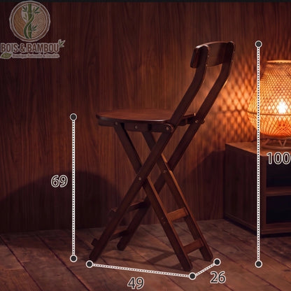 Tabouret de Bar en Bambou marron dimensions 1. Schéma d'un haut tabouret pliant marron avec mesures : hauteur totale 100 cm, assise à 69 cm, largeur 49 cm et profondeur 26 cm, dans un décor tamisé.