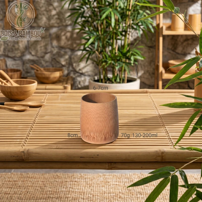 Tasse en Bambou Carbonisé Rétro Mini Tasse Saké Thé Café – posée sur table bois entourée de bambous naturels, esthétique wabi-sabi zen éco-responsable.