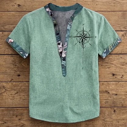 Chemise homme en fibre de bambou manches courtes verte, col mandarin ouvert et liseré fleuri tropical, imprimé boussole poitrine