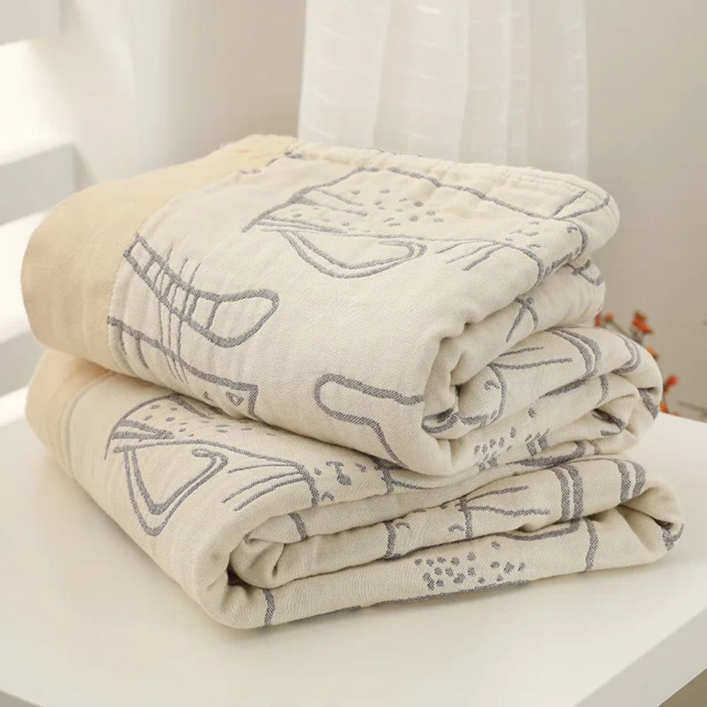 Couverture en gaze de coton bambou pliée, tissage motif chat visible
