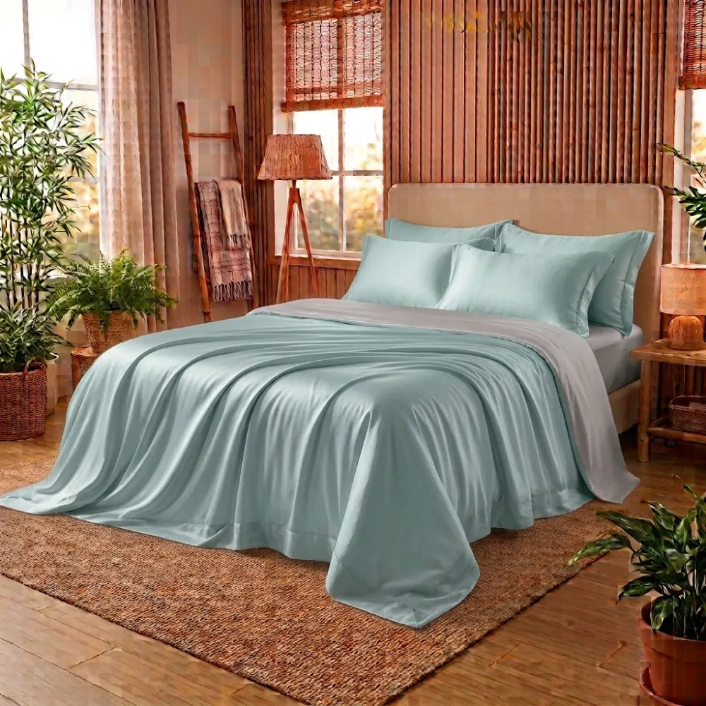 Housse de couette en bambou vert d'eau et gris sur un lit
