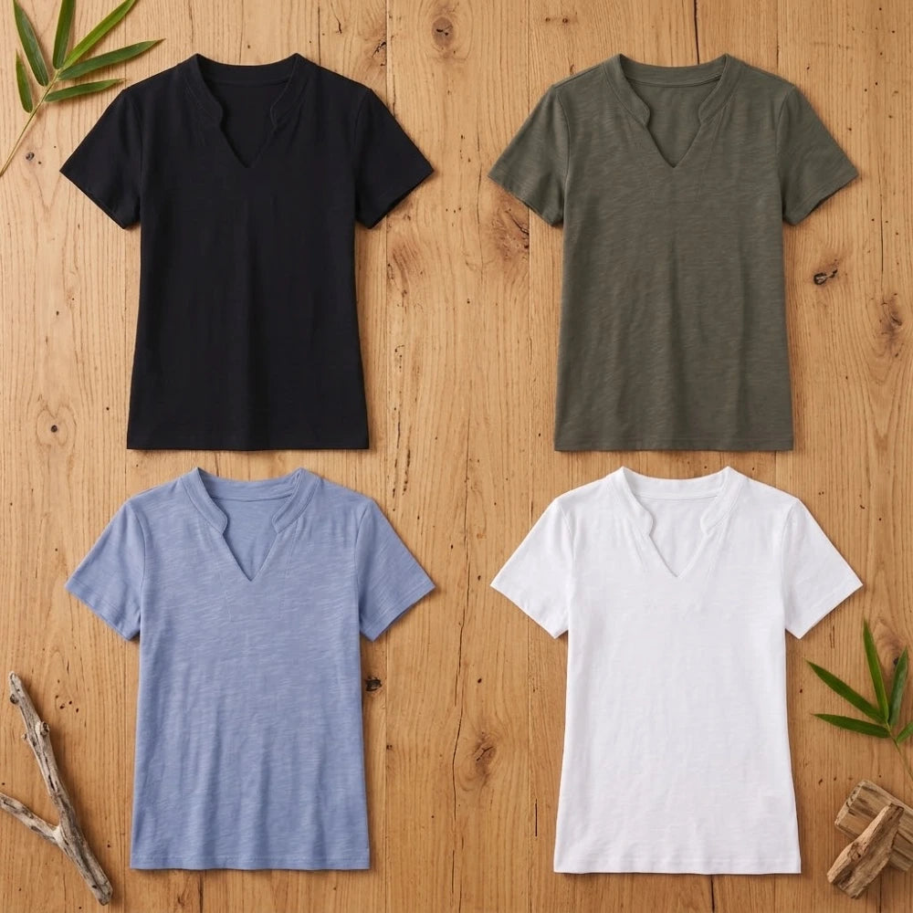 T-shirts femme col V en coton et fibre de bambou présentés à plat en noir, kaki, bleu et blanc sur fond bois naturel