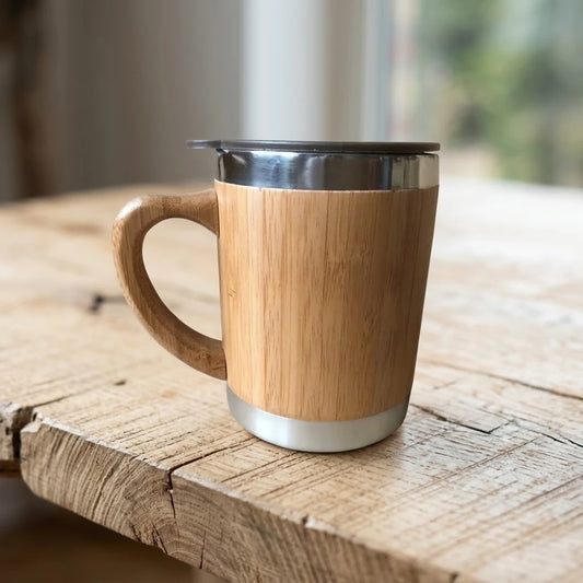 Tasse en bambou isotherme avec anse, 300 ml, coque en bambou naturel et couvercle inox, sur bois brut